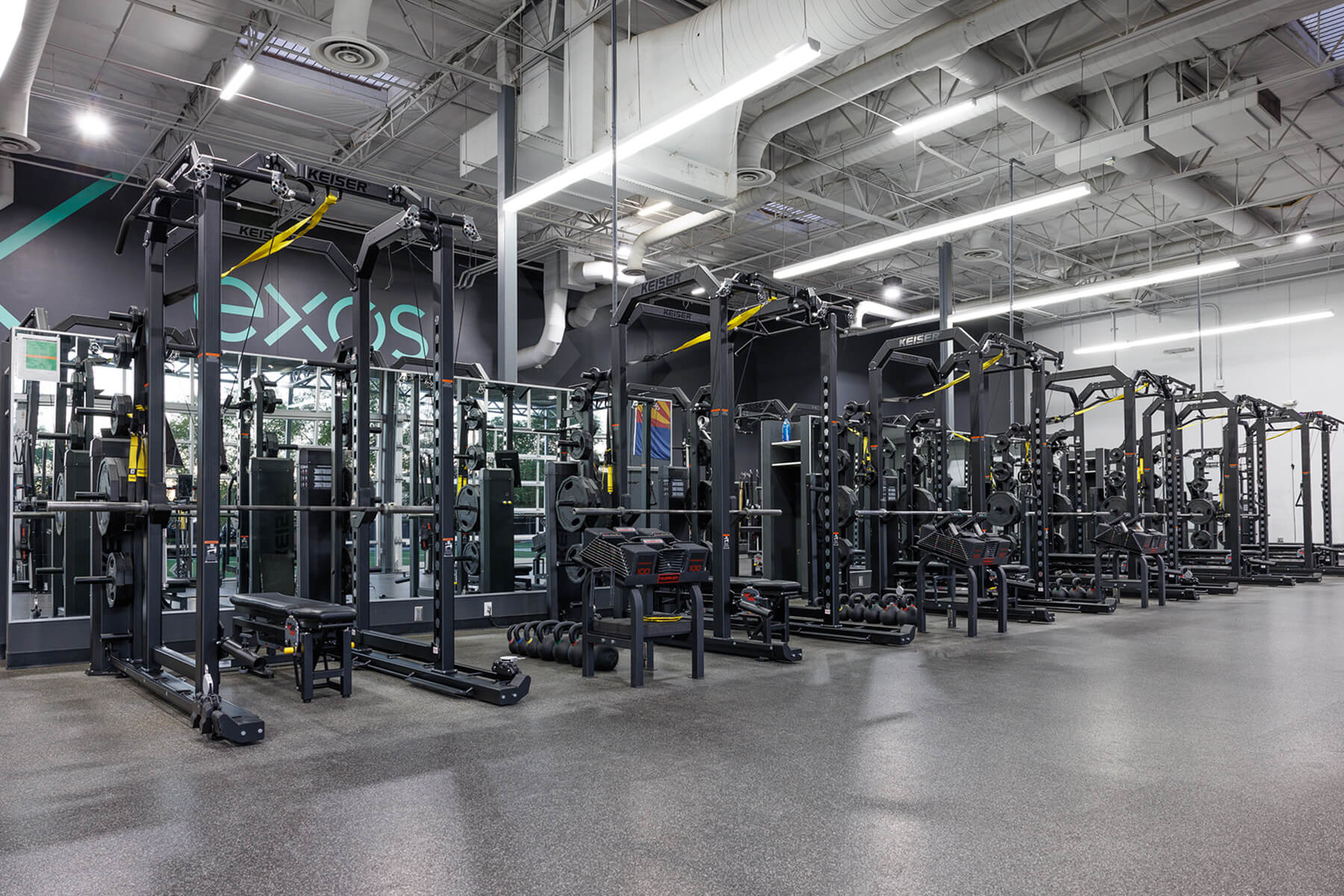 Several Keiser Power Racks lined up at Exos