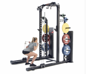 Woman performing continuous squat jumps use bar and pneumatic resistance on a Keiser Half Rack