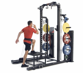 Man performing explosive step up jumps using Keiser pneumatics with belt resistance on a Keiser Half Rack