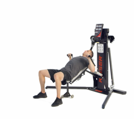 Man performing alternating incline chest press on Keiser Functional Trainer