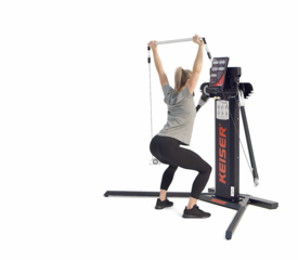 Woman performing an Overhead Squat on a Keiser Functional Trainer