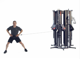 Man performing a lateral walk on a Keiser Performance Trainer in a Six Pack configuration