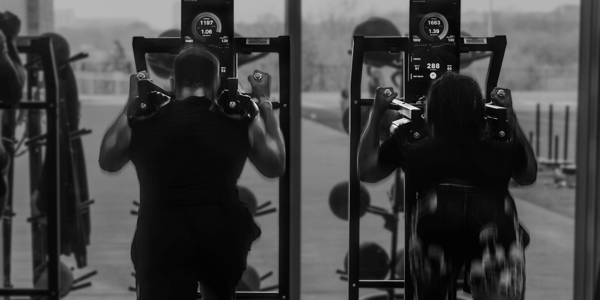 Two men on Keiser A400 squat machines at Exos' NFL Combine training