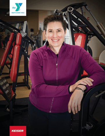 South Shore YMCA director of health and well being at her fitness facility leaning on Keiser resistance equipment. 