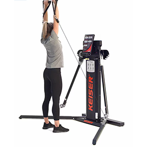 Woman performing bicep curl to press on Keiser functional trainer