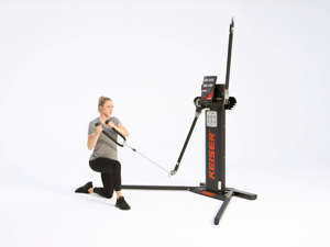 Woman performing half kneeling cable lift on Keiser Functional Trainer cable machine