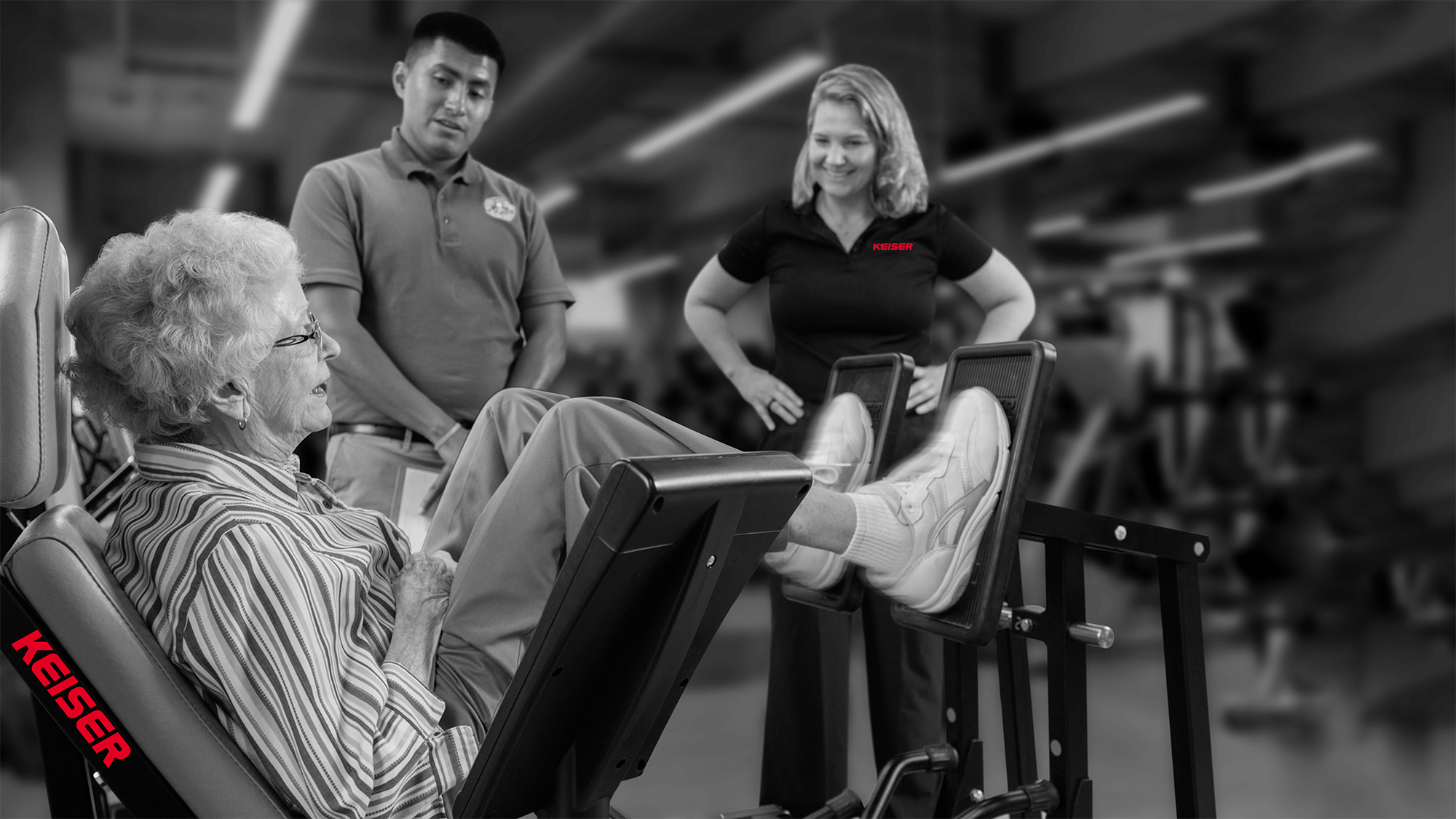 Keiser and community wellness staff with a resident on a Keiser Lefg Press