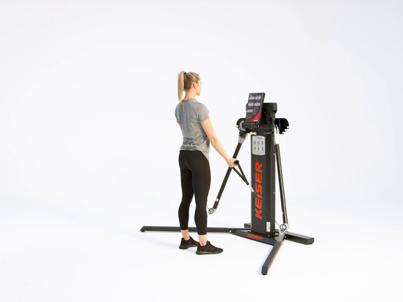 Woman on cable machine conducting bicep curl to press