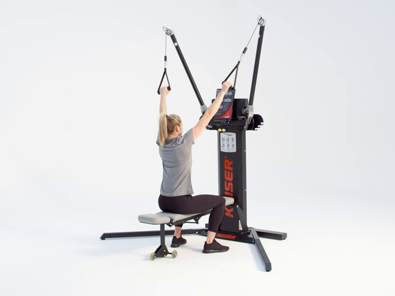 woman at cable machine conducting seated high to low row