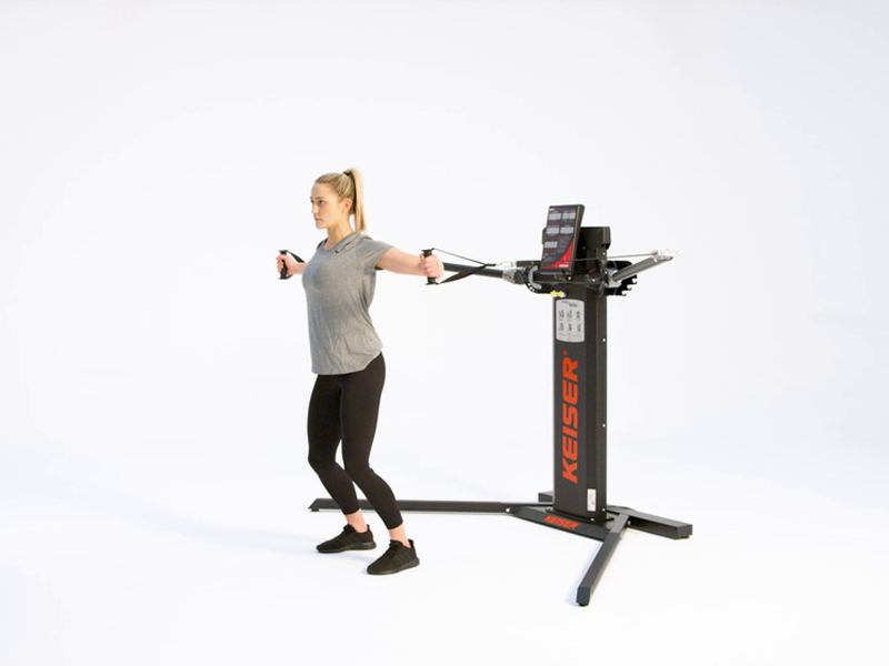 woman on cable machine conducting standing cable flies