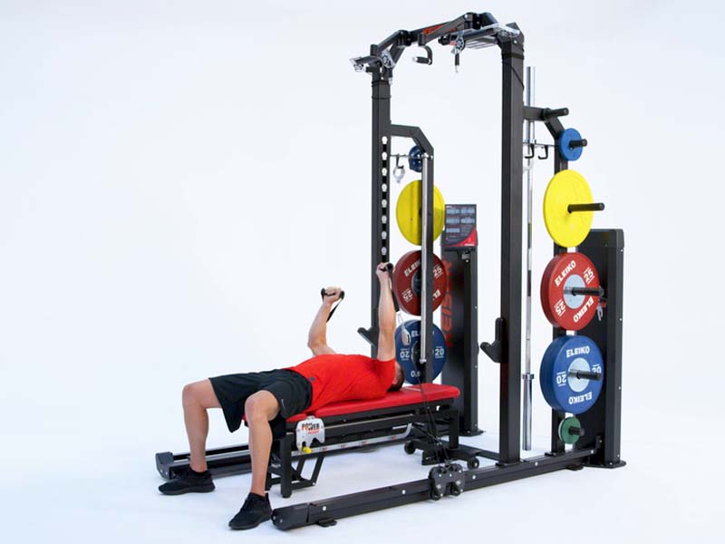 Man on rack performing alternating bench press with pneumatic resistance