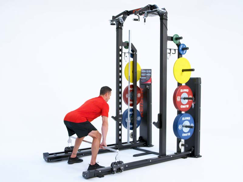 Man at Rack performing pneumatic resisted Bent Over Row