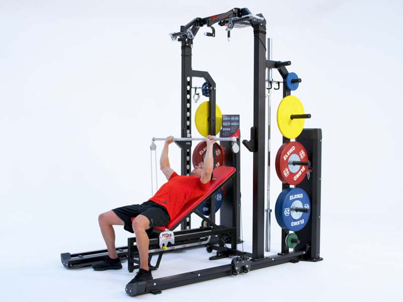 Man on Rack performing pneumatic resisted Incline Bench with Bar