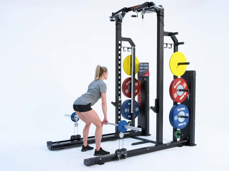 Woman at Rack performing mixed resistance high pull