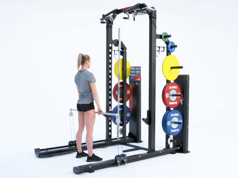 Woman at Rack performing pneumatic resisted upright row