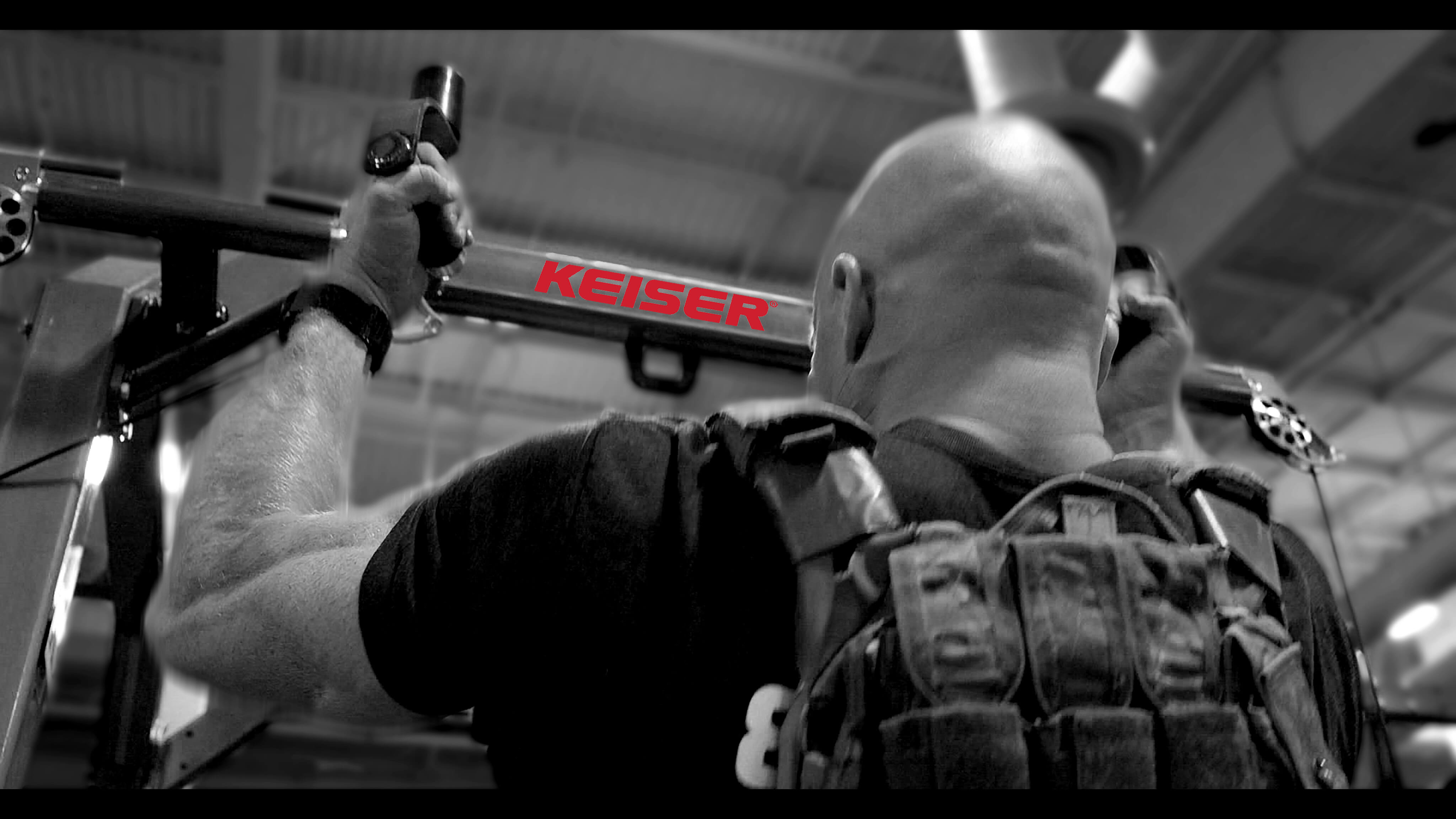 Special Operator performing weighted pull ups on Keiser Rack