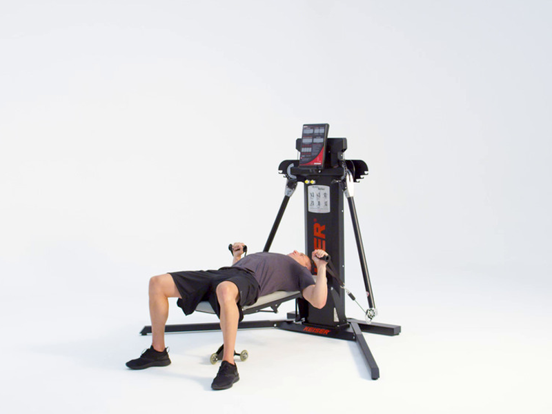 man conducting flat bench chest press at cable