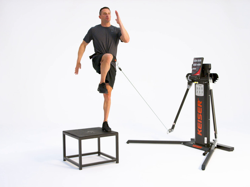 Man on Functional Trainer conducting cross over step ups