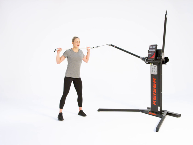 woman conducting a lateral lunge at pulley machine