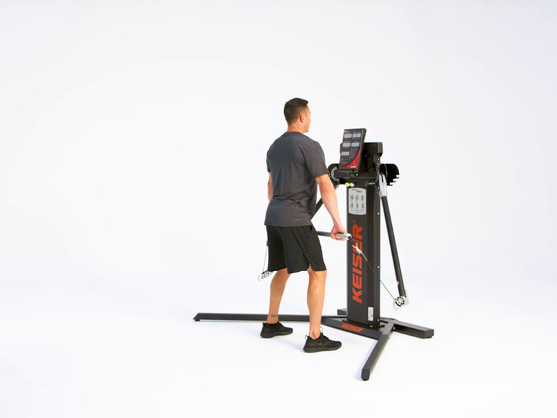 man conducting shrugs on cable machine