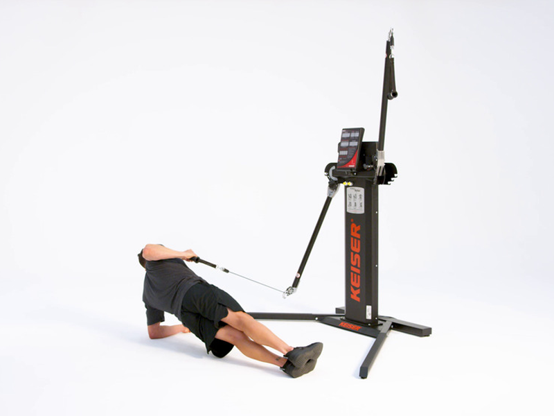 Man on functional trainer conducting side plank with row