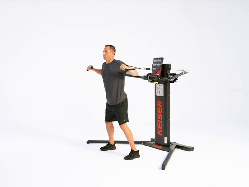 man conducting Standing Diagonal Chest Press on cable machine